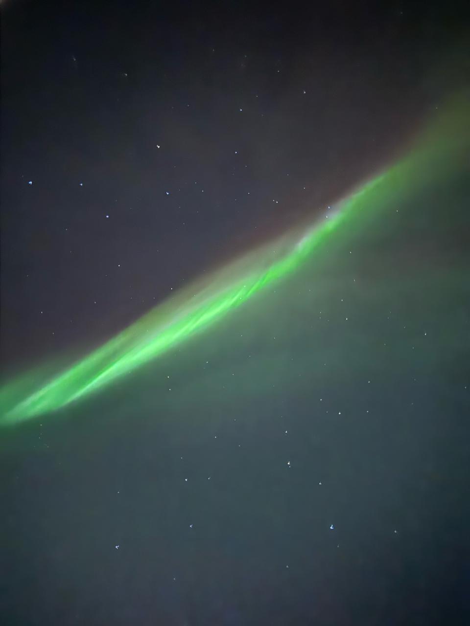 Aurora crossing a field of stars